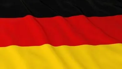 Waving flag of Germany with black, red, and gold stripes.