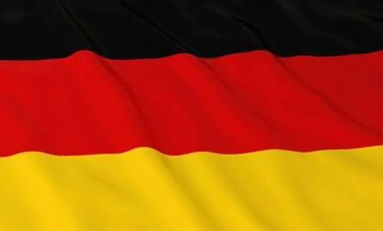 Waving flag of Germany with black, red, and gold stripes.