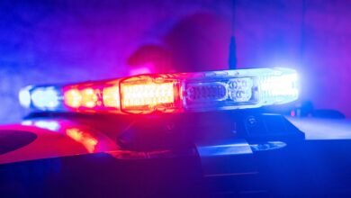 Close-up of a police car light bar with red and blue flashing lights.