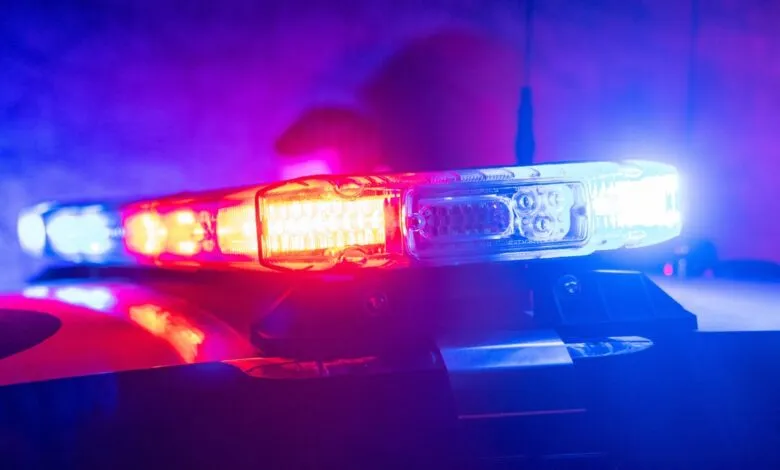 Close-up of a police car light bar with red and blue flashing lights.
