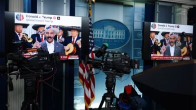 Press briefing room showing screens with Donald Trump tweet and cameras.