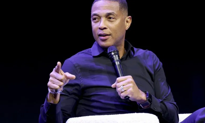Don Lemon speaks into microphone on stage, gesturing with his hand.