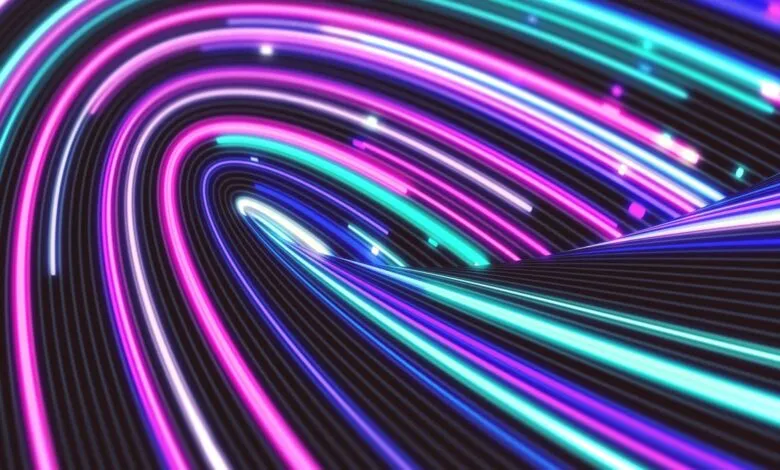 Abstract neon light trails in pink, blue, and purple on a dark background.