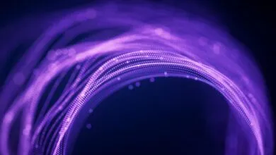 Abstract purple light trails forming a circular shape on dark background.