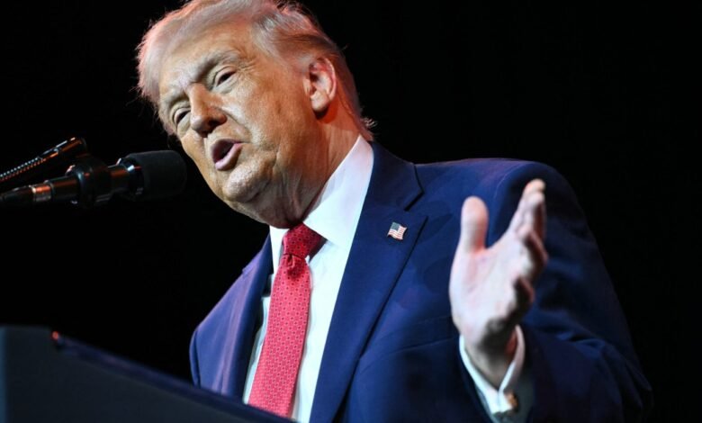 Donald Trump speaking at a podium with a microphone.