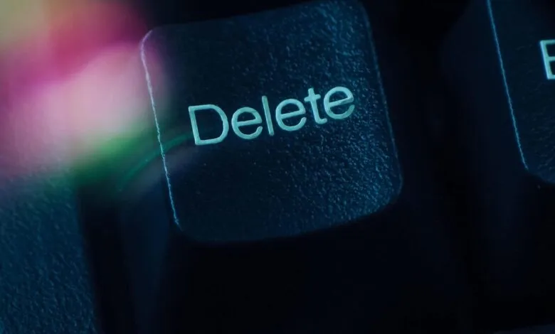 Close-up of a 'Delete' key on a dark computer keyboard.