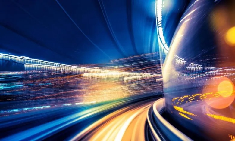 Abstract view from inside a speeding train at night, blurred lights.