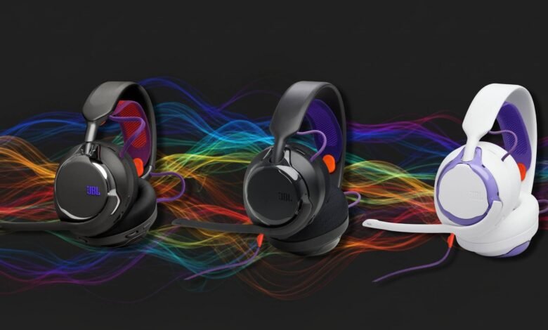 Three JBL Quantum gaming headsets in different colors on a dark background.