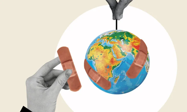 Globe with bandages held by hands, symbolizing global healing.