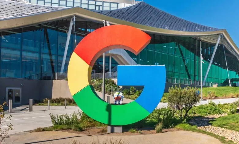 Google's colorful logo stands in front of its modern headquarters.