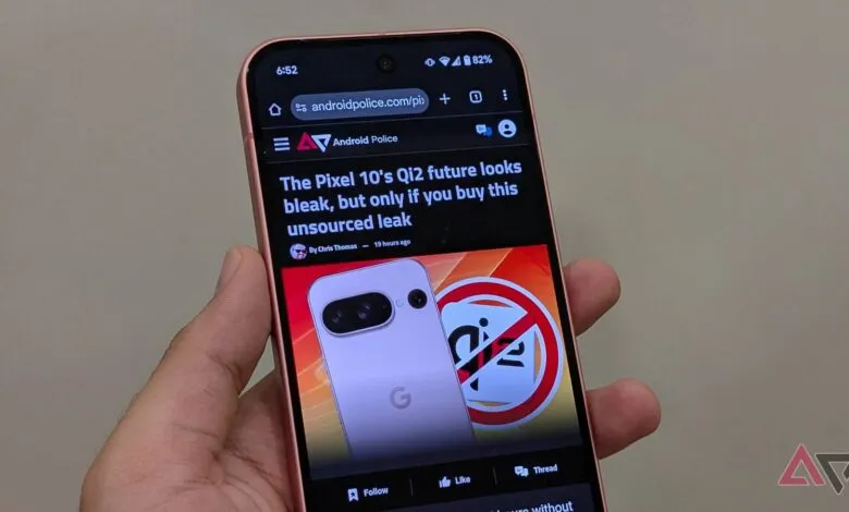 Hand holding a Google Pixel phone displaying an Android Police article.