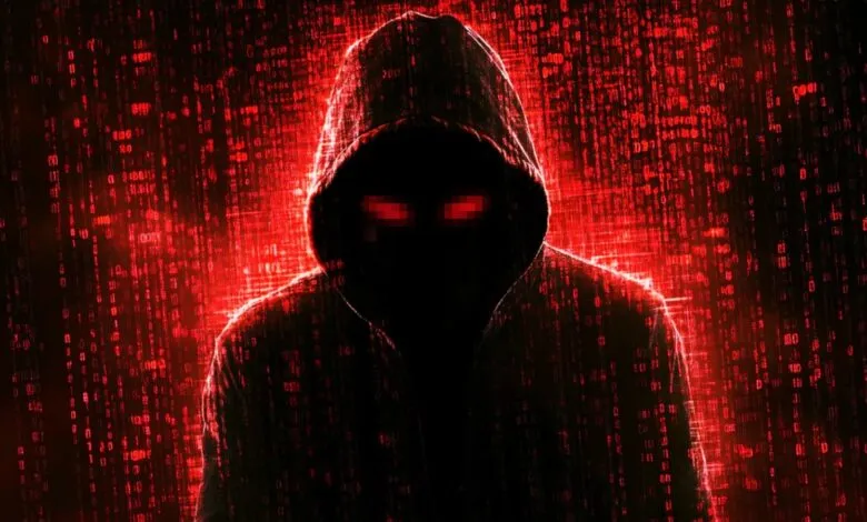 Person in hoodie with pixelated red eyes against a digital matrix background.