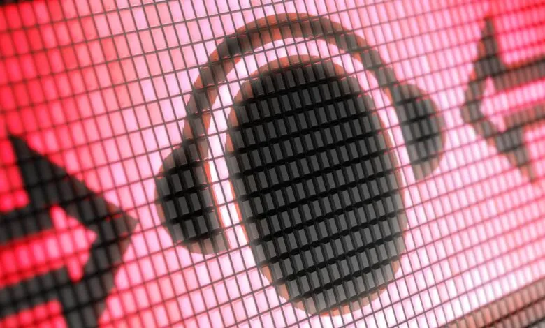 Pixelated headphones icon on a red grid background.