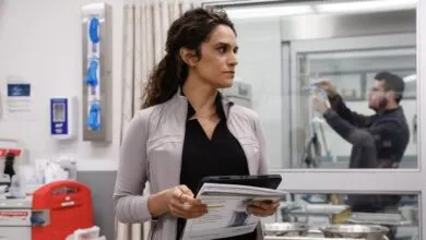 Healthcare worker reviews documents in a clinical setting.