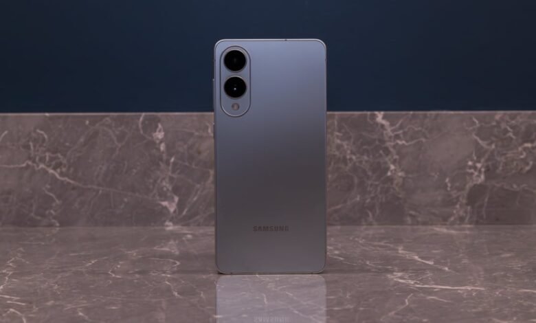 Back of gray Samsung phone with camera lenses on marble surface.