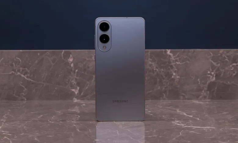 Back of gray Samsung phone with camera lenses on marble surface.