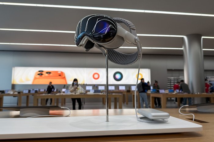 Apple Vision Pro headset on display in a store setting.
