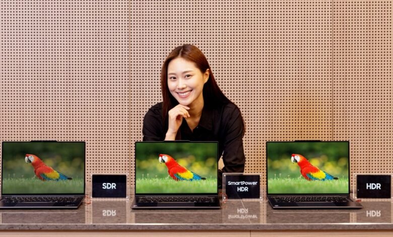 Woman displays laptops showing parrot image with SDR, SmartPower HDR, and HDR options.