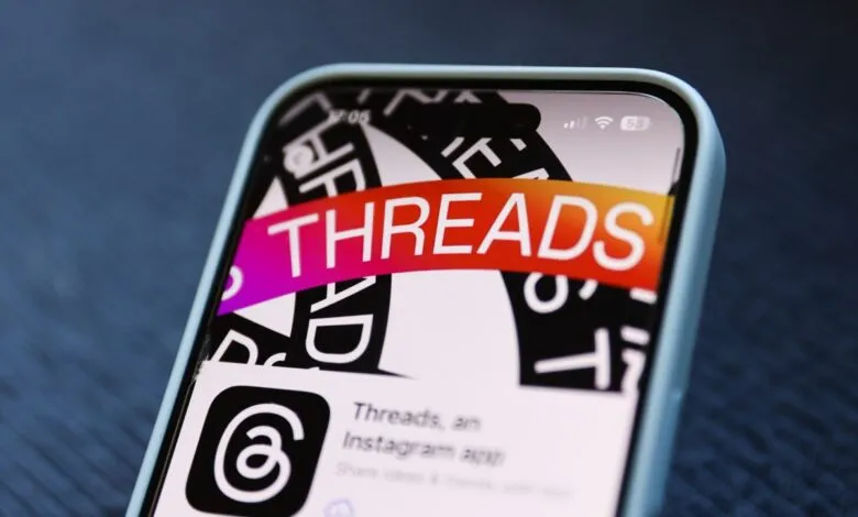 Close-up of a smartphone screen displaying the Instagram Threads app icon.