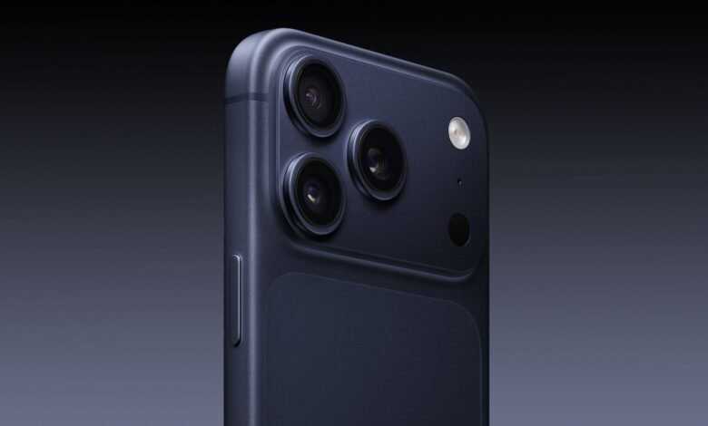 Close-up of a dark blue smartphone with three camera lenses.