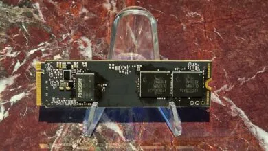 Close-up of a black M.2 NVMe SSD on a clear plastic stand.