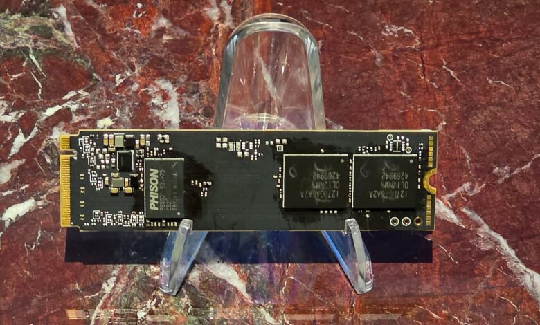Close-up of a black M.2 NVMe SSD on a clear plastic stand.
