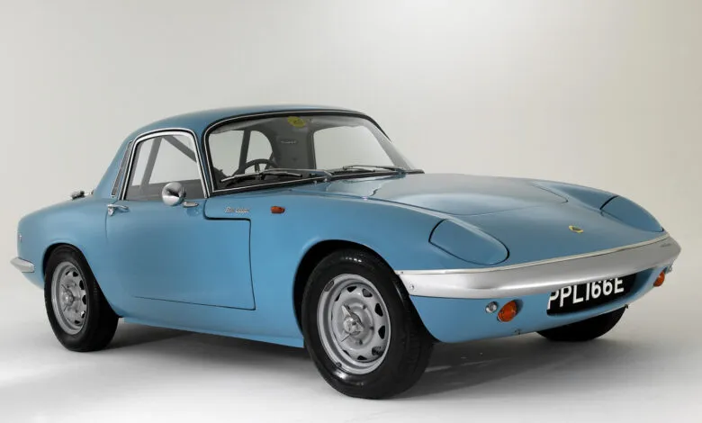 Light blue Lotus Elan Coupe with silver trim and black tires on a white background.