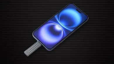 iPhone connected to a silver SSD drive on a striped background.