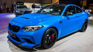Bright blue BMW M2 CS coupe with black wheels and red brake calipers.