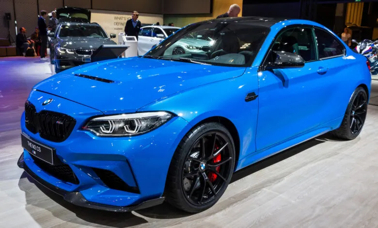 Bright blue BMW M2 CS coupe with black wheels and red brake calipers.