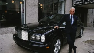 Ralph Lauren poses with a black Bentley outside Manhattan Motorcars.