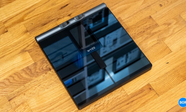 Wyze smart scale on a light wood floor, angled view.