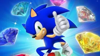 Sonic the Hedgehog gives a thumbs up surrounded by Chaos Emeralds.