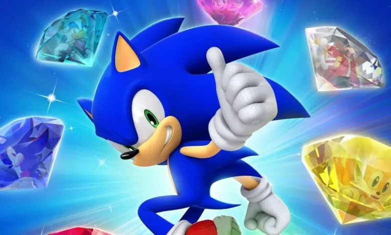 Sonic the Hedgehog gives a thumbs up surrounded by Chaos Emeralds.