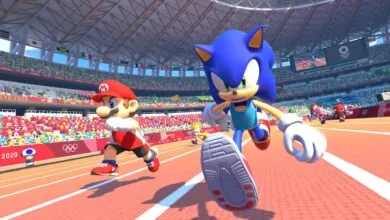Mario and Sonic race on a track in a stadium filled with cheering crowds.