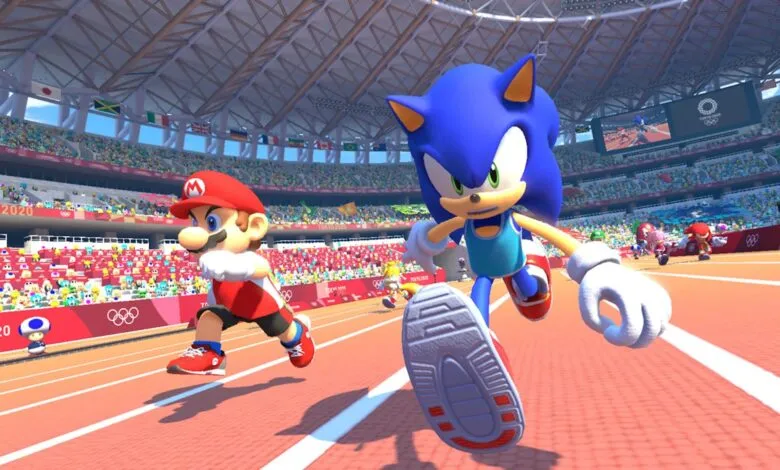 Mario and Sonic race on a track in a stadium filled with cheering crowds.