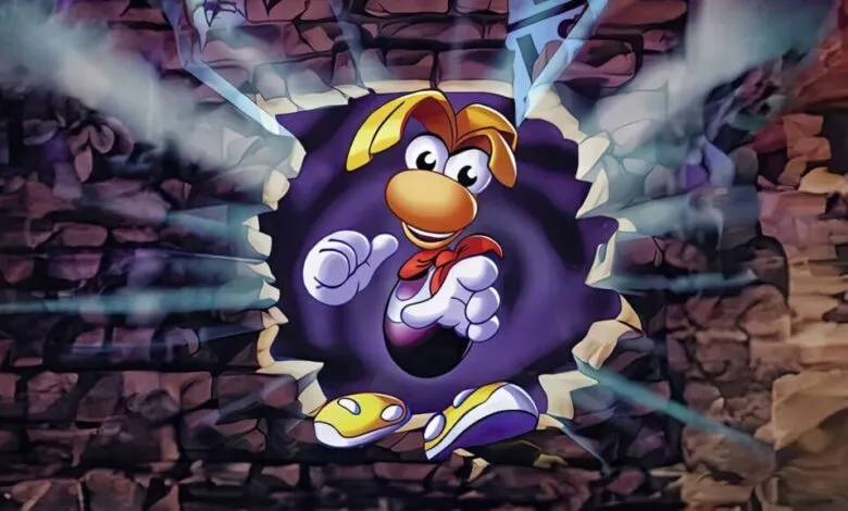 Rayman bursts through a brick wall in a dynamic, cartoonish style.
