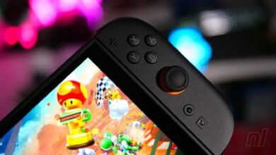 Close-up of a Nintendo Switch OLED playing Mario Kart, focus on controller.