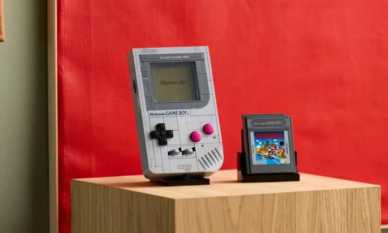 Lego Nintendo Game Boy with Super Mario Land cartridge on wooden surface.