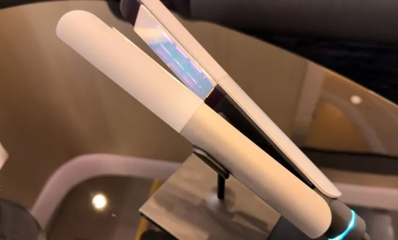 Modern white hair straightener on display stand.