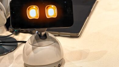 Loona robot desk companion with animated eyes on screen.