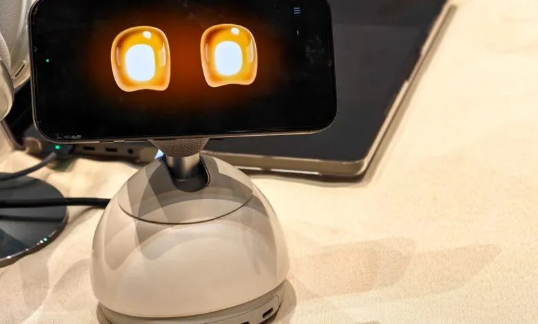 Loona robot desk companion with animated eyes on screen.