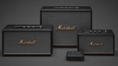 Three Marshall speakers and a small device on a gray background.