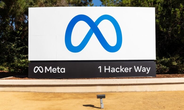 Meta headquarters sign with infinity logo and address: 1 Hacker Way.