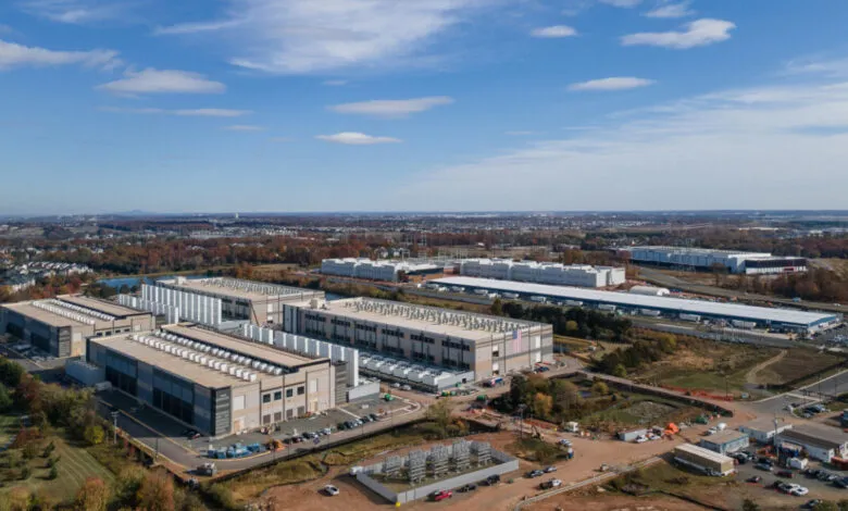 Aerial view of a large Microsoft data center complex with multiple buildings and parking lots.