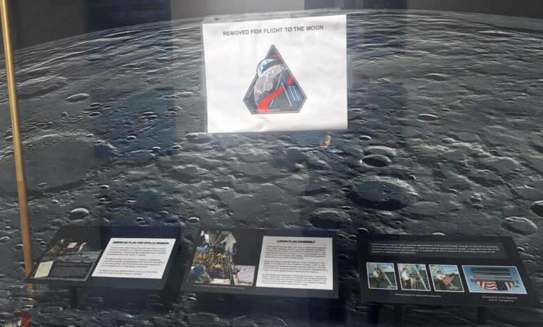 Lunar exhibit featuring moon surface backdrop and Apollo mission information.