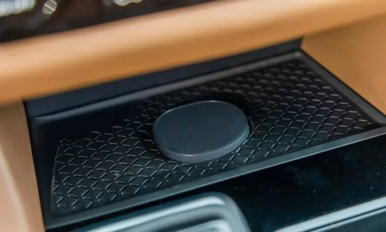 Wireless charging pad sits in a car's center console.