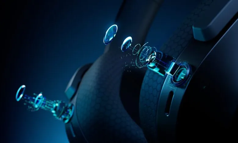 Close-up of black headphones with glowing blue tech details.