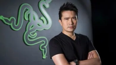Min-Liang Tan, Razer CEO, poses in front of the Razer logo.