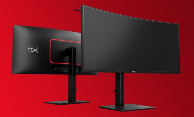 Two HyperX Armada 27 gaming monitors on stands against a red background.